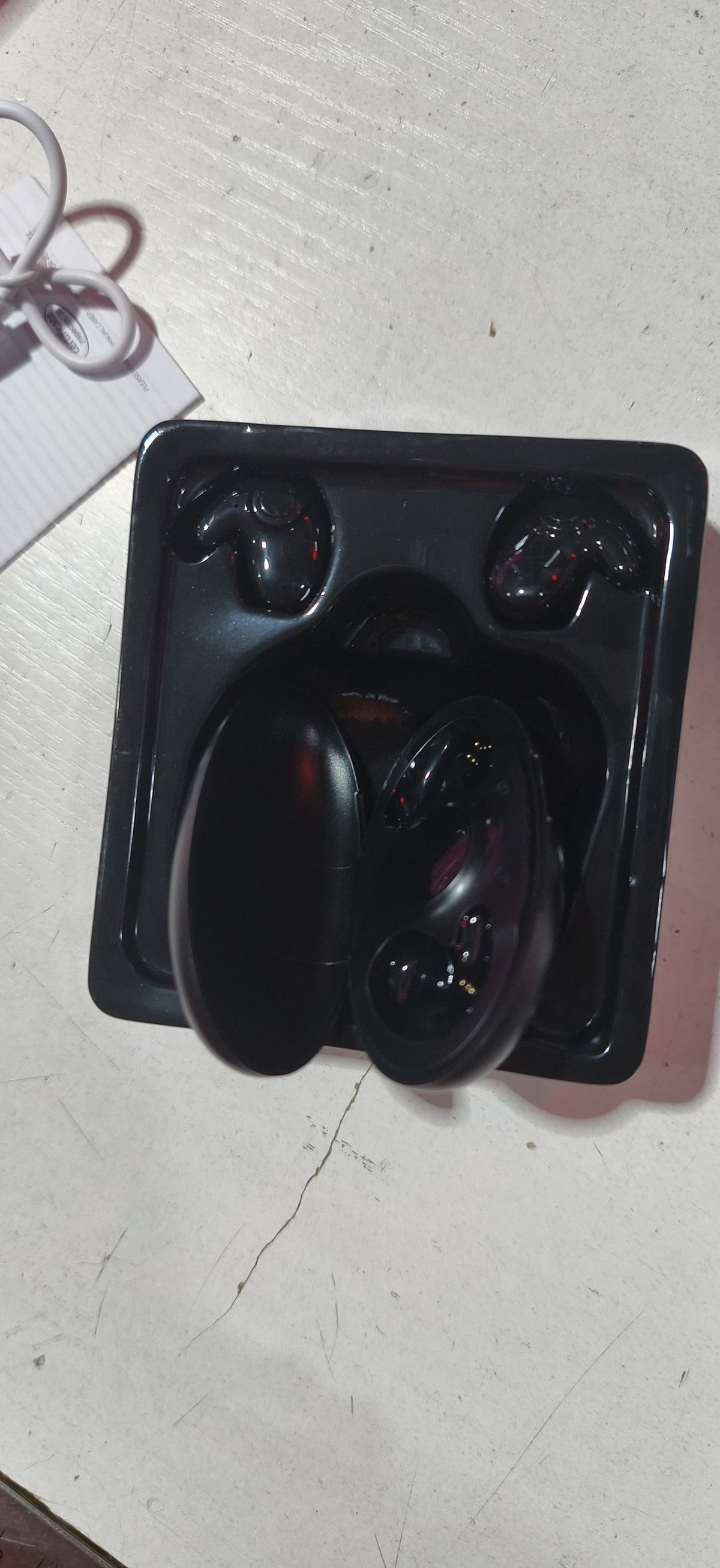 Fone Bluetooth sem fio na palma da mão, mostrando o tamanho compacto